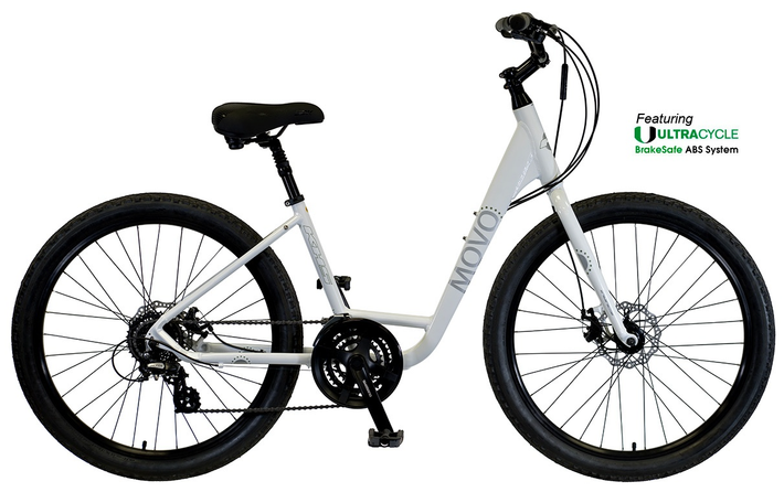 Blue bicycles parked on a lawn in front of a building with a tiled roof.