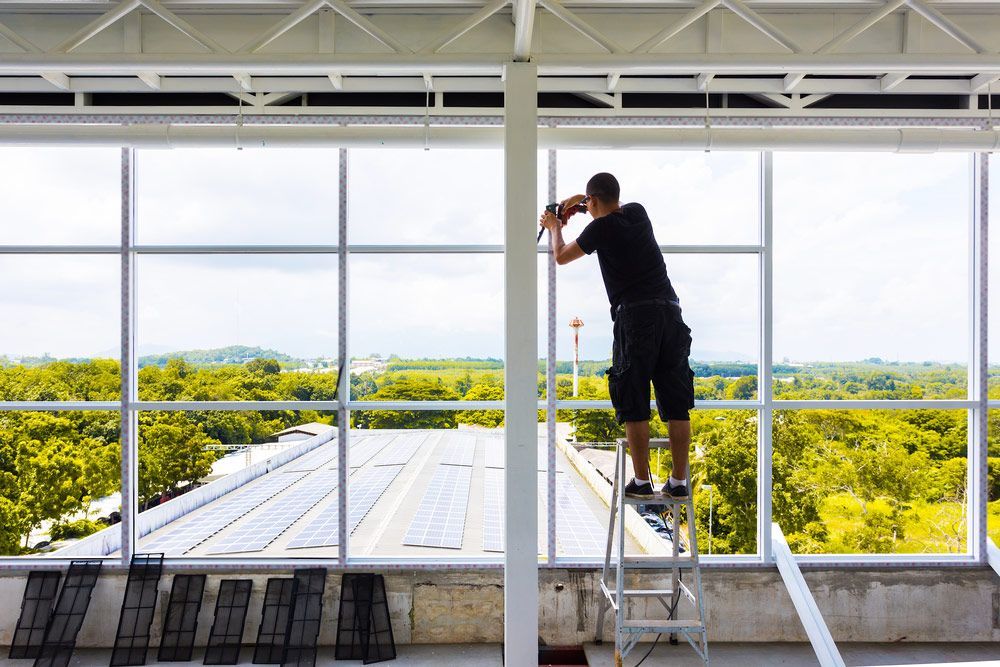 Man Doing Repairs on Glass Panel