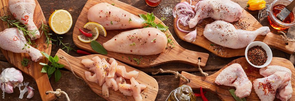 There are many different types of chicken on the cutting boards.