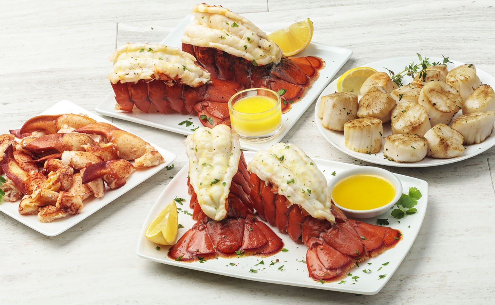 There are many different types of seafood on the plates.