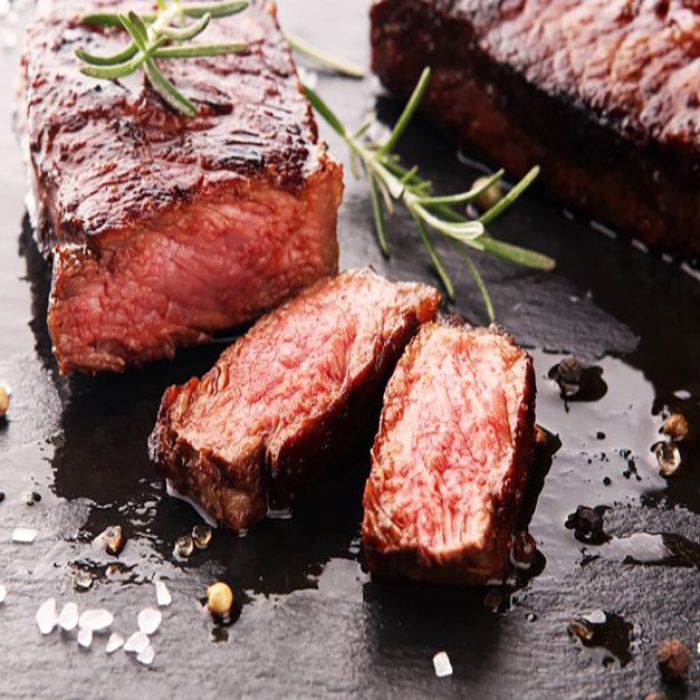 A close up of a piece of steak on a table
