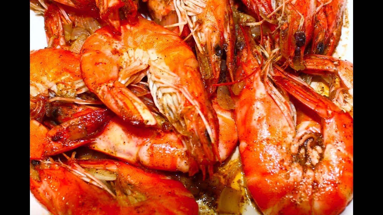 A close up of a plate of shrimp on a table.