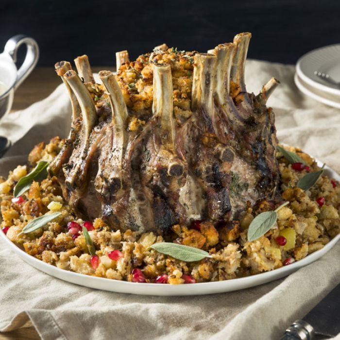 A white plate topped with meat and stuffing on a table