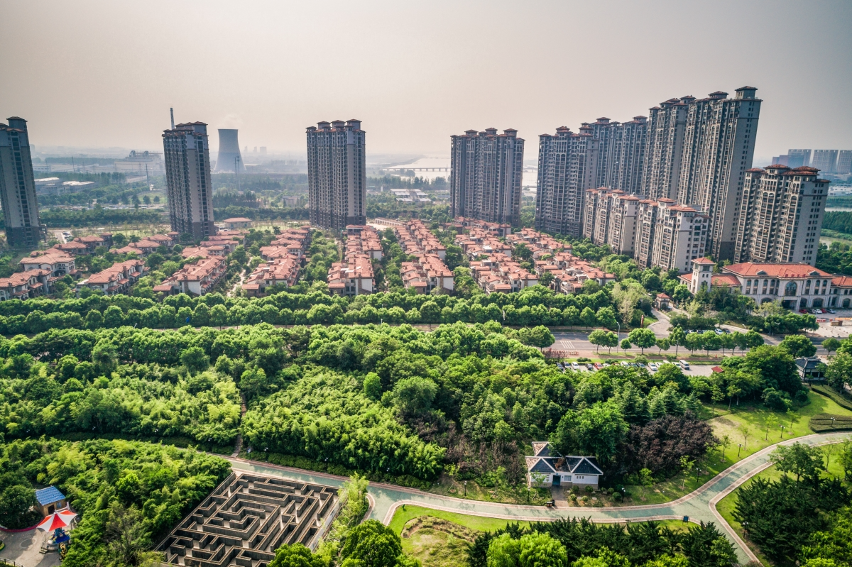 An aerial view of a city with lots of buildings and trees.
