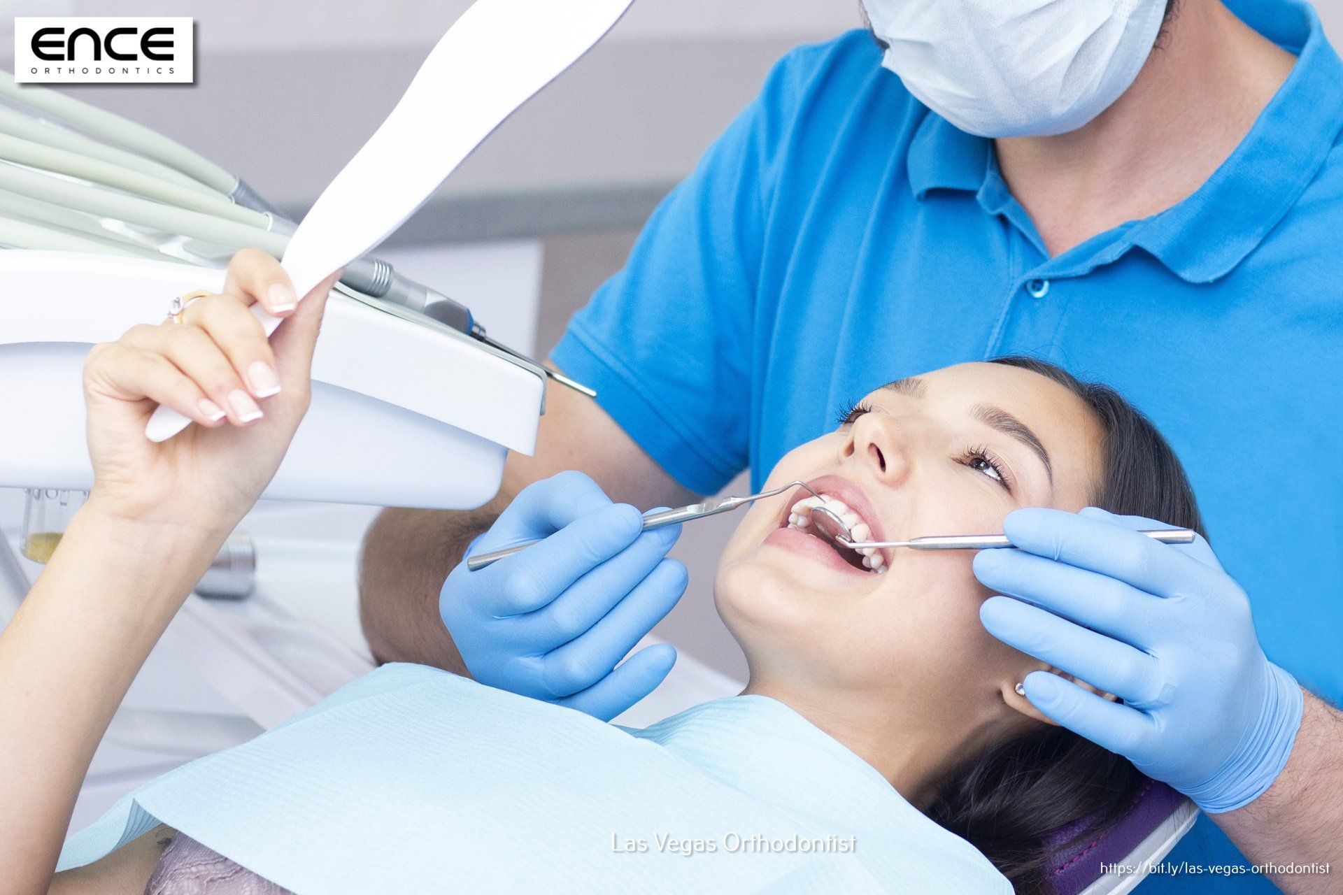 A woman is getting her teeth examined by a dentist
