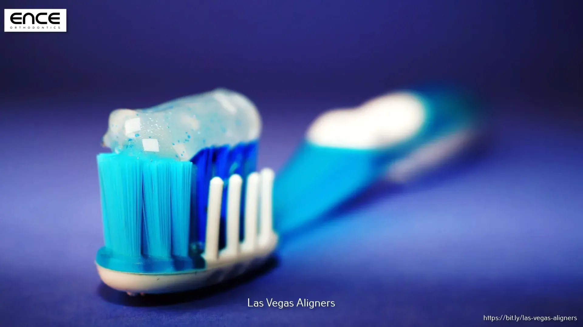 A blue and white toothbrush with toothpaste on it