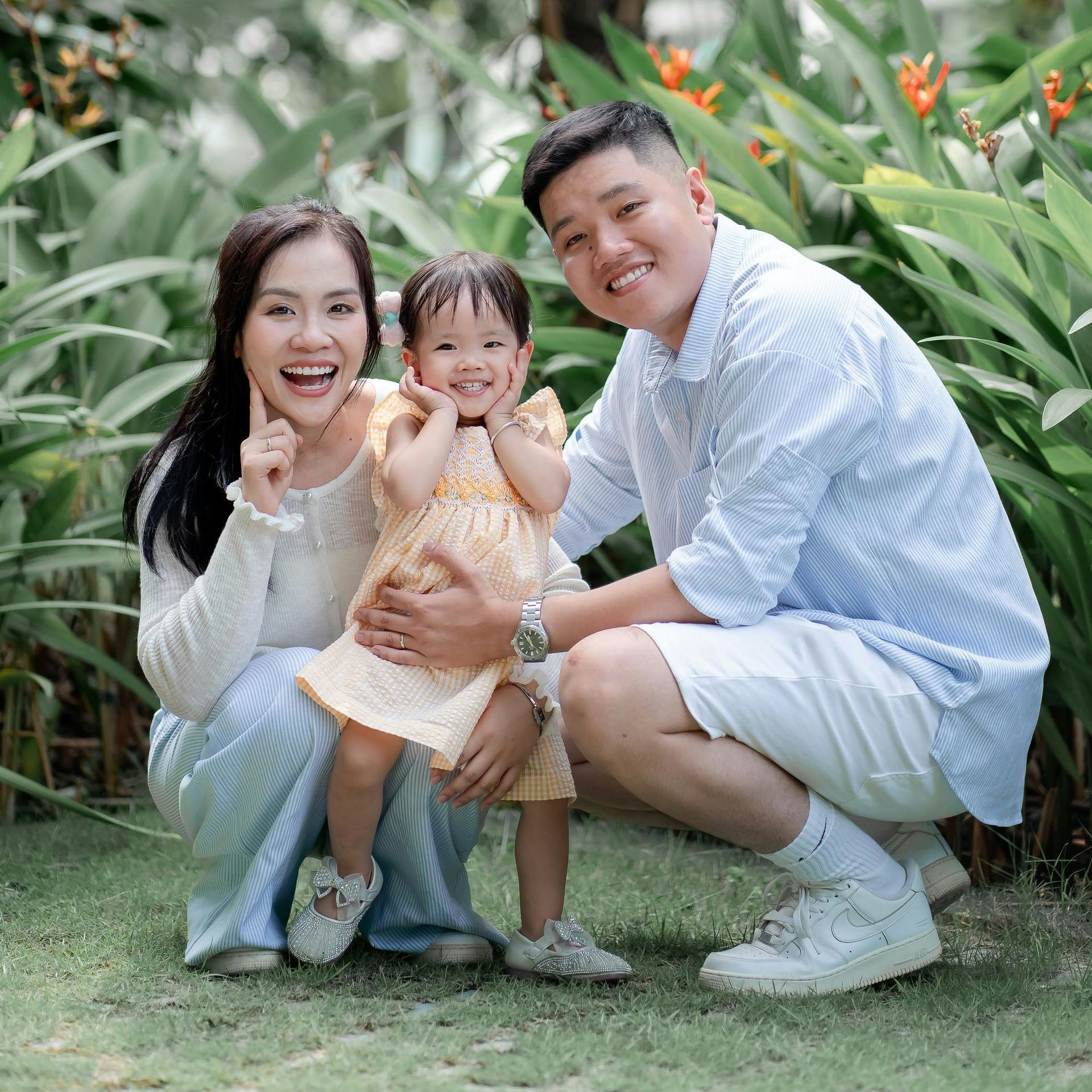 A woman in a white shirt is standing in a grassy field