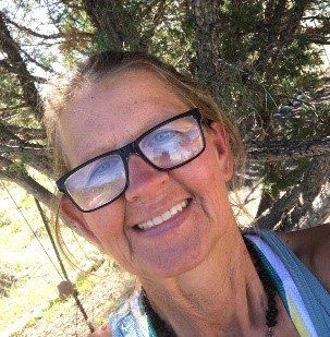 A young boy with braces on his teeth is smiling for the camera.