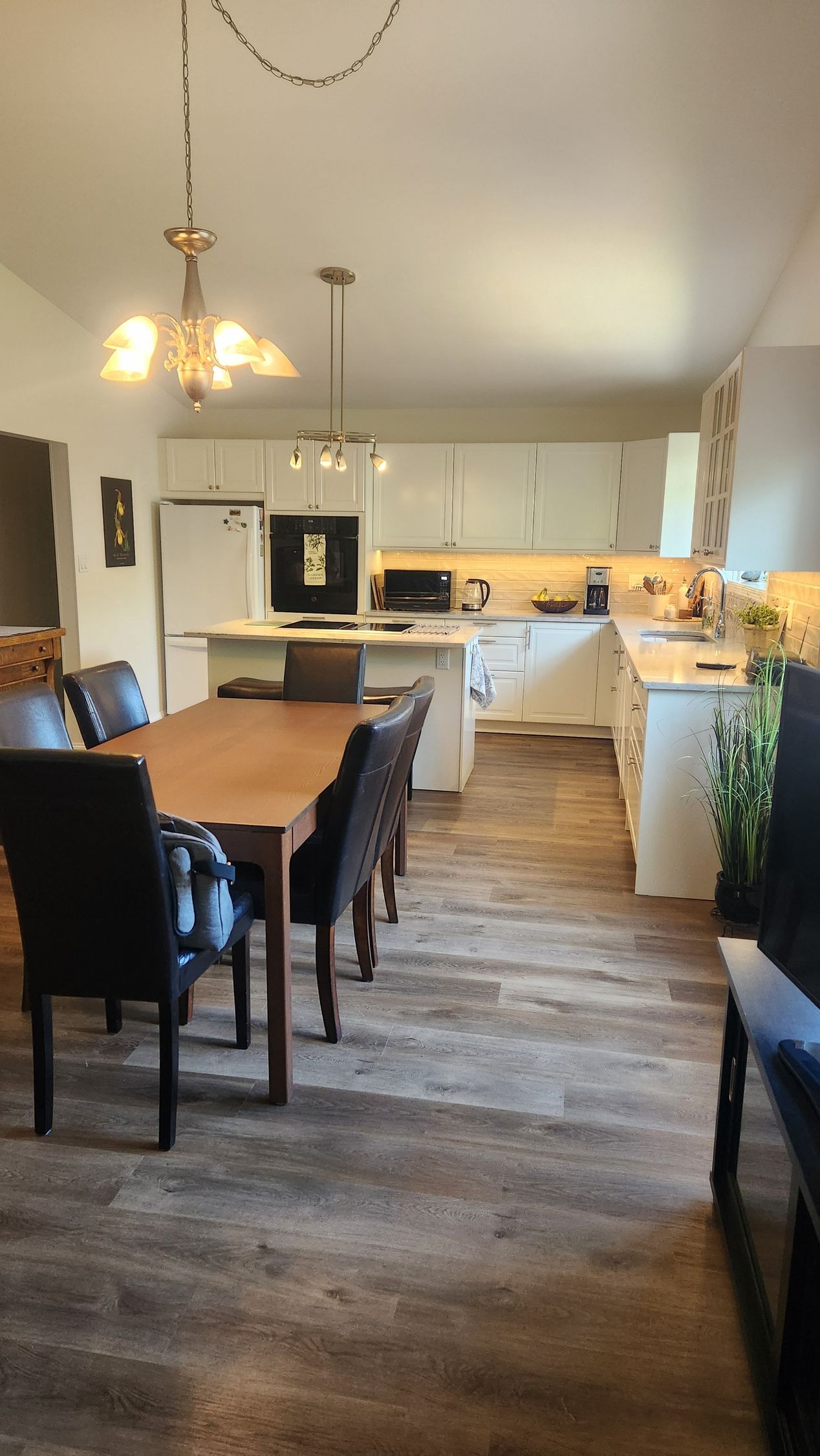 A kitchen with a table and chairs in it