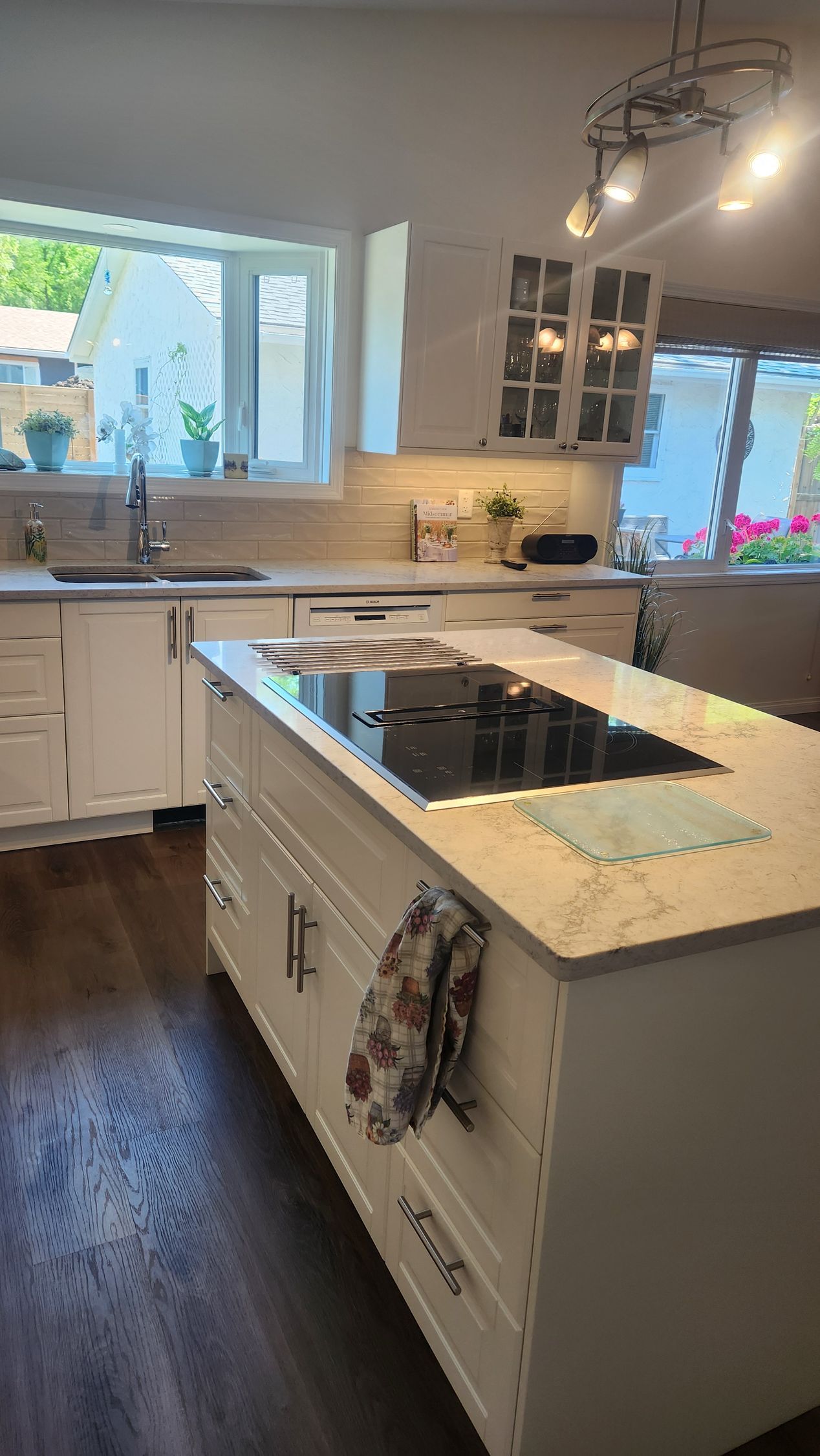 A kitchen with a large island and a stove top oven.