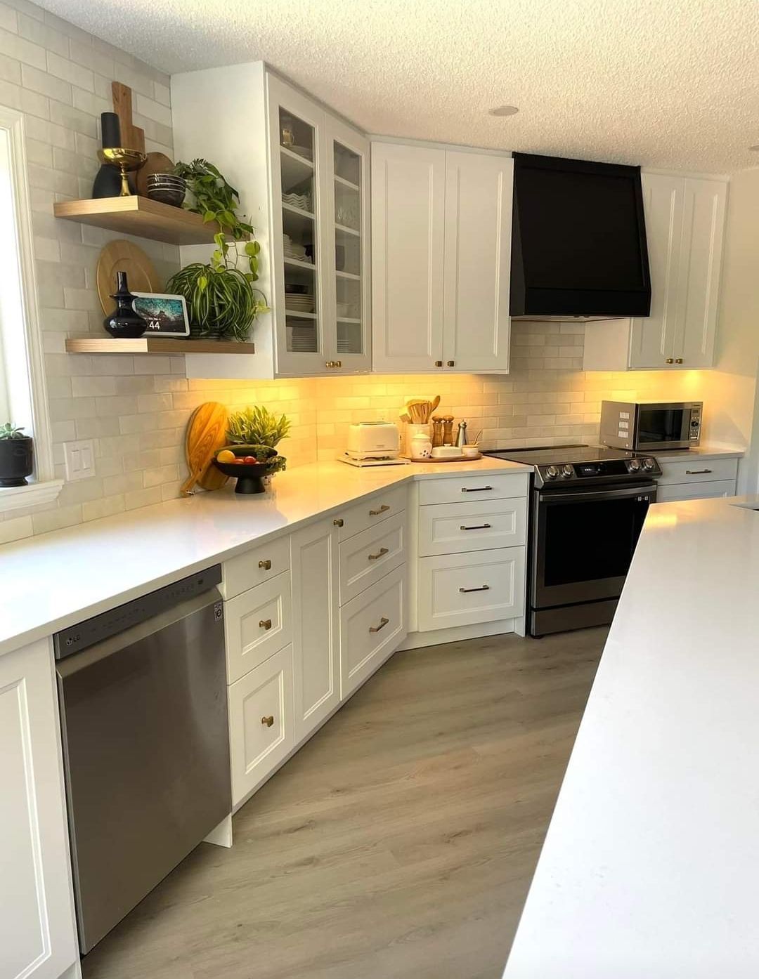 A kitchen with white cabinets and stainless steel appliances