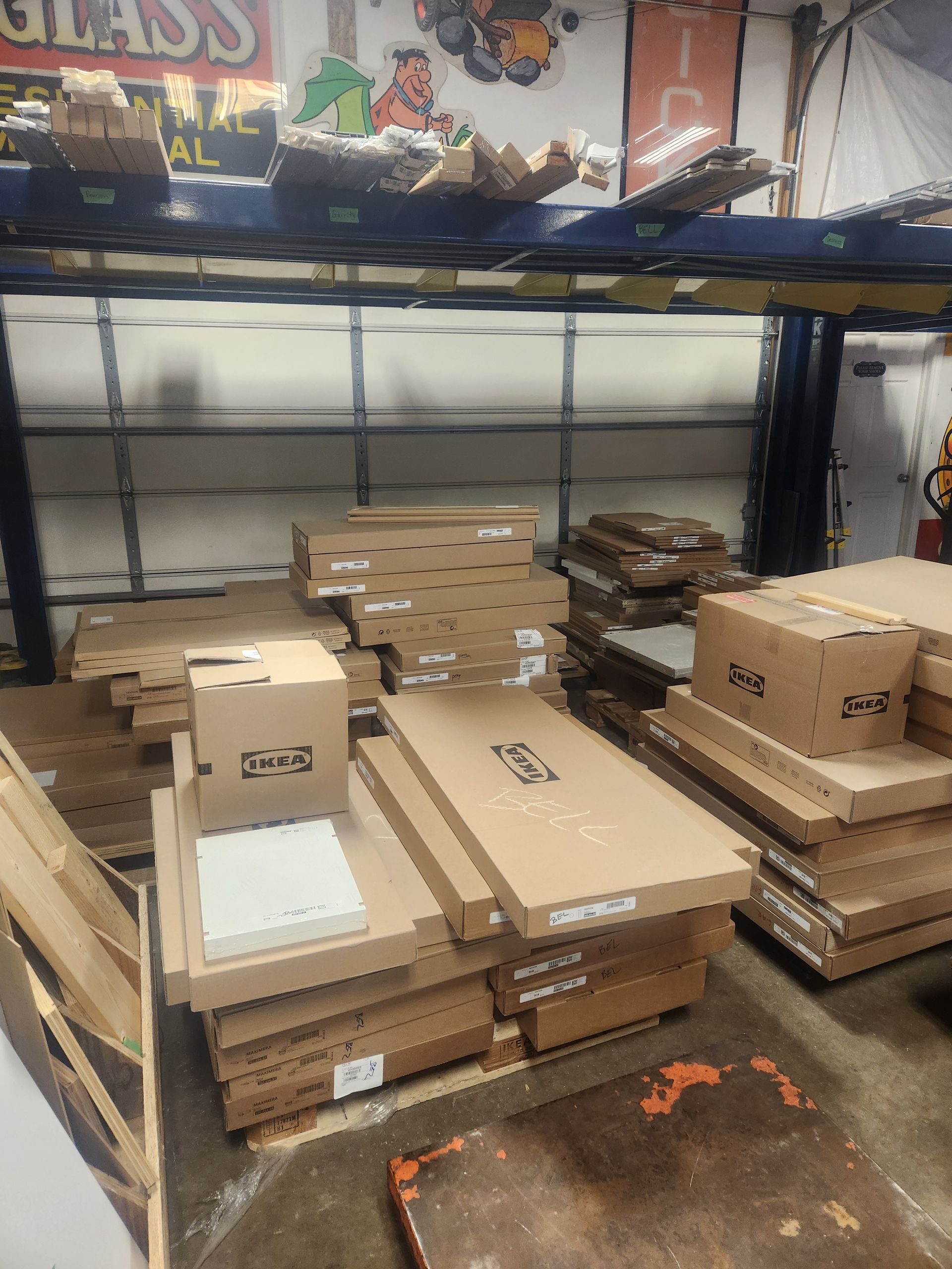 A warehouse filled with lots of boxes and a sign that says glass