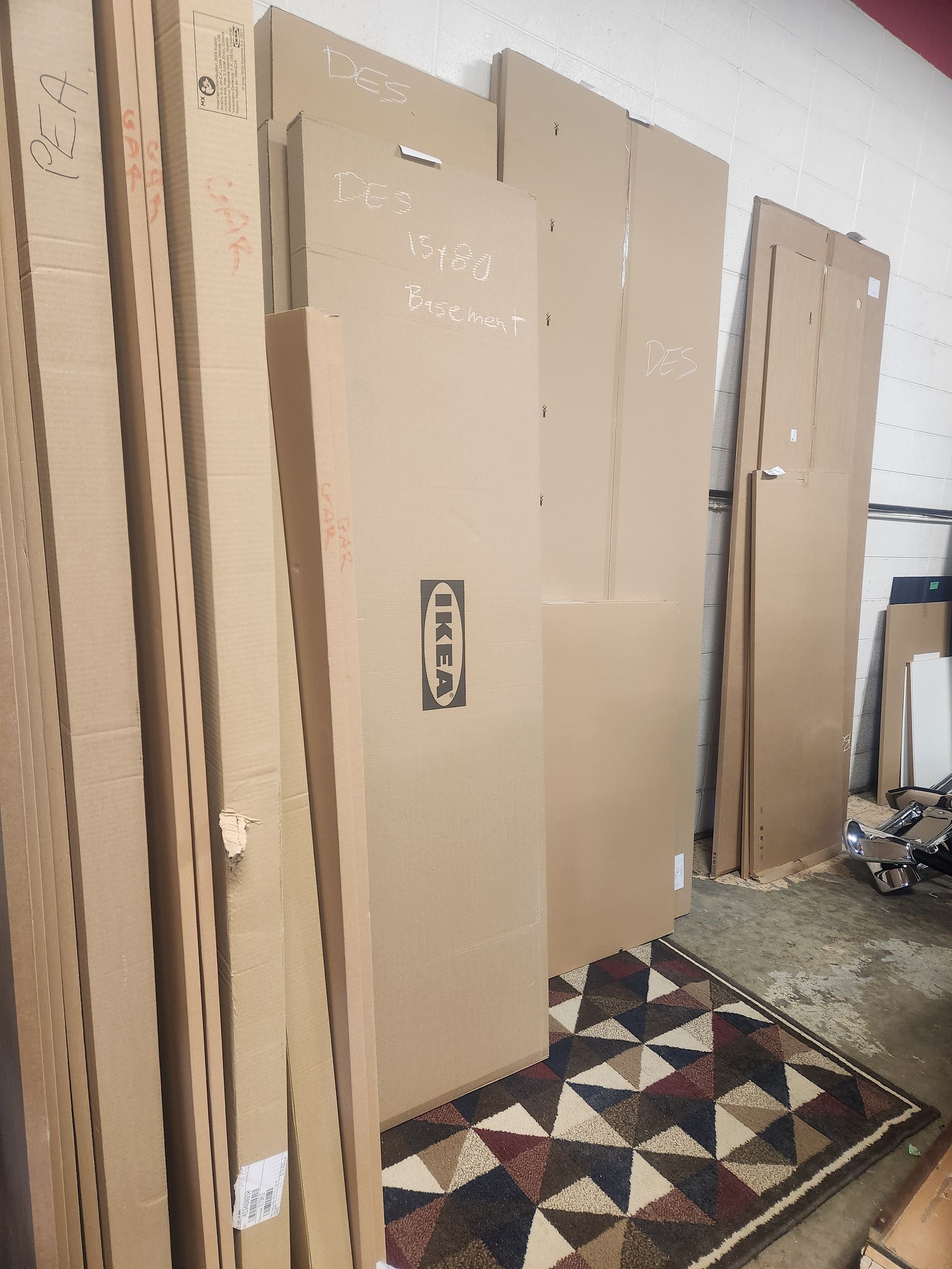 A bunch of cardboard boxes are stacked on top of each other in a room.