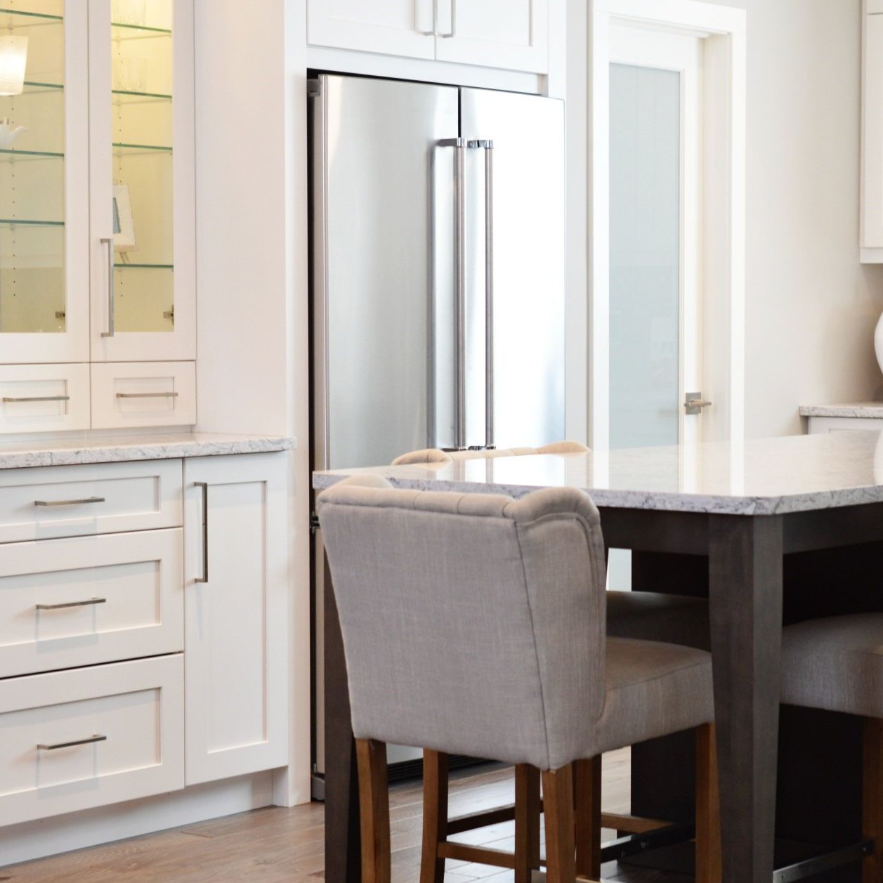 A kitchen with a table and chairs and a refrigerator