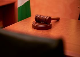 Judge’s gavel on a wooden desk in a courtroom