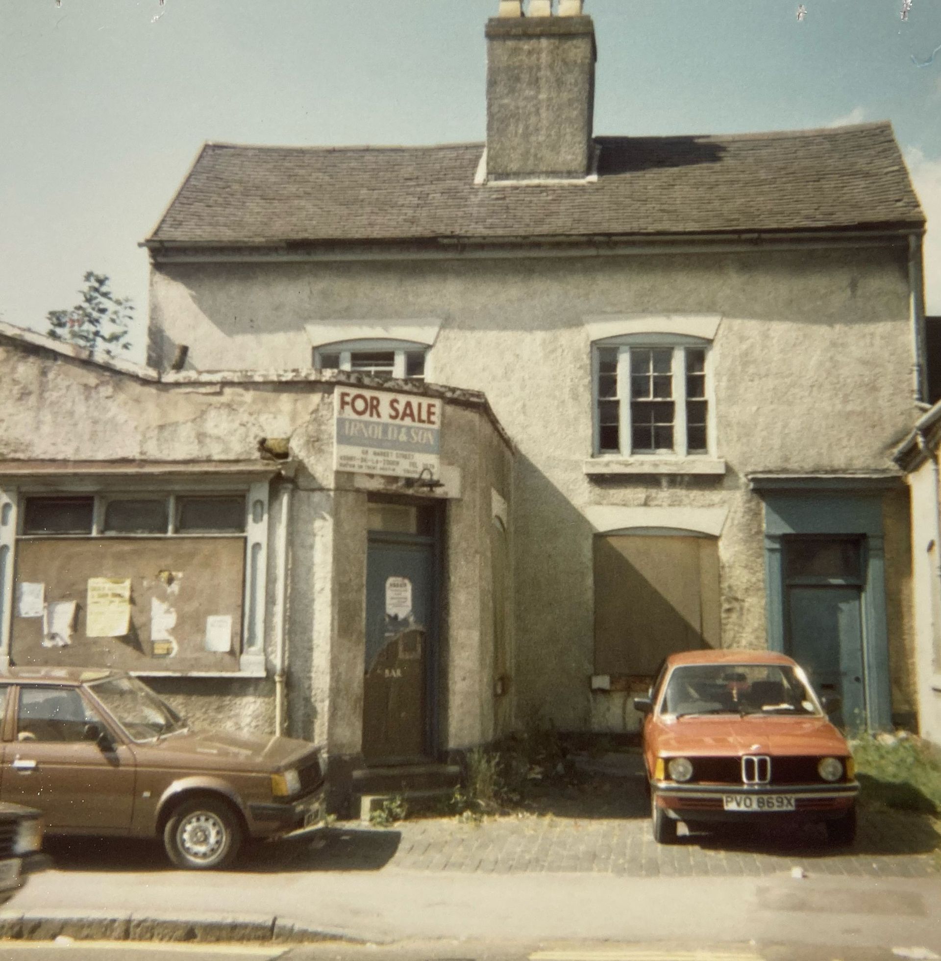 A for sale sign is on the side of a building