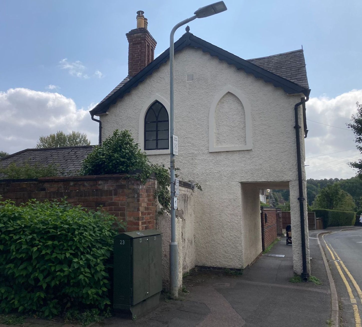 A white building of the Priest House as of 2024.