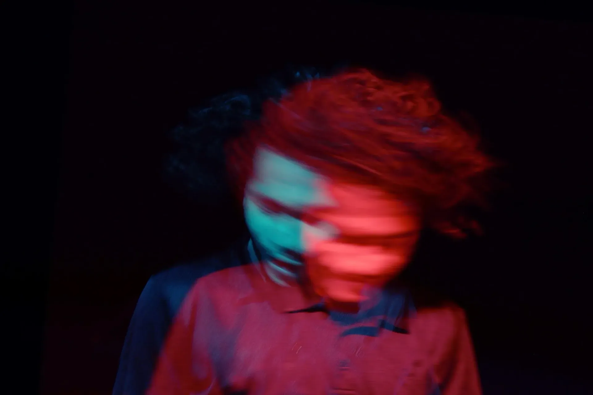 Green-tinted motion blur inside a tunnel, with bright light at the center