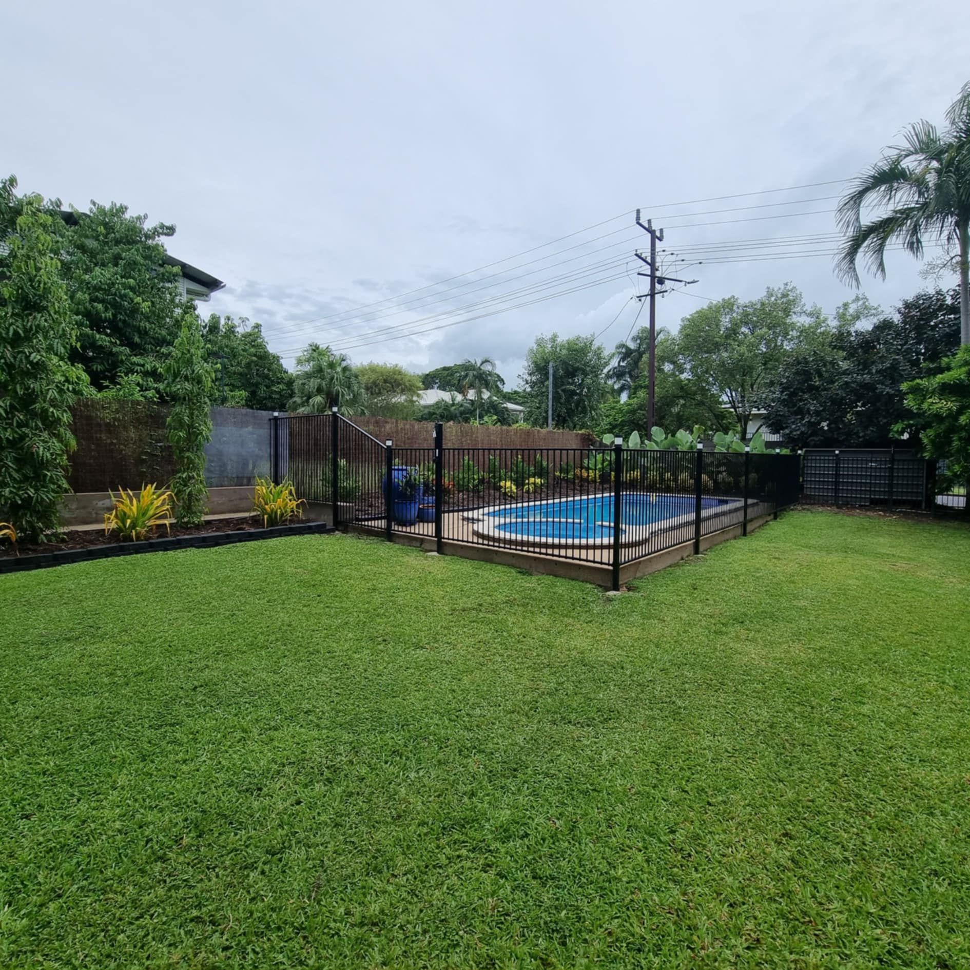 A Large Lush Green Yard With Trees And Bushes On A Sunny Day — City 2 Bush Mowing Services Darwin In Howard Springs, NT