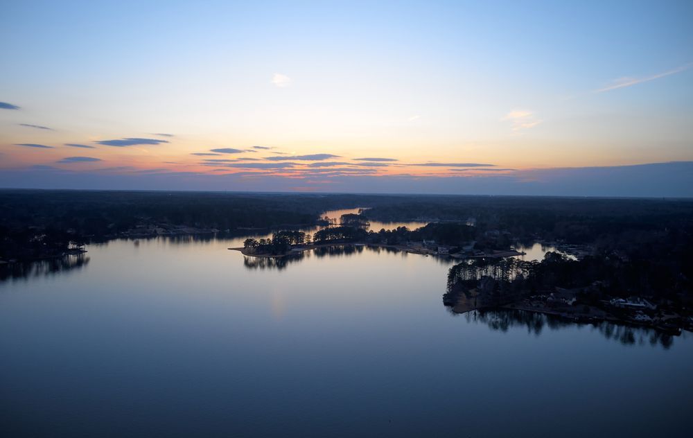 an aerial view of a lake at sunset