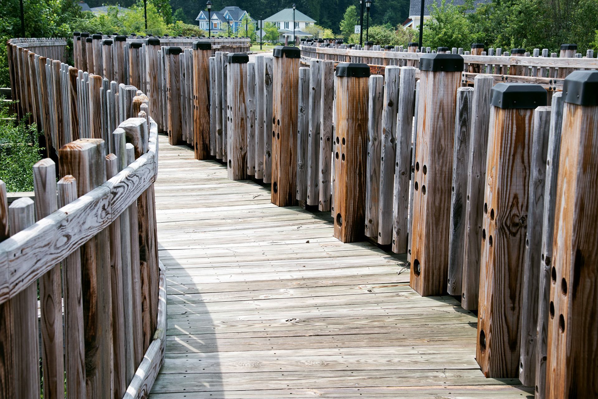 a wooden walkway with a fence surrounding it