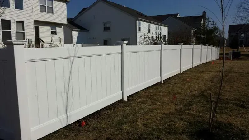 A brick walkway with a gate and stairs leading to a house.