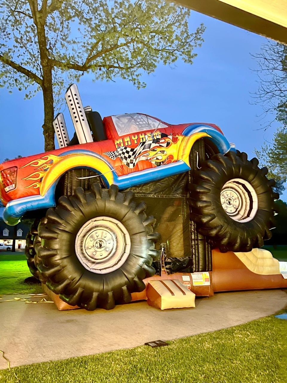 A large inflatable monster truck is sitting on top of a ramp.