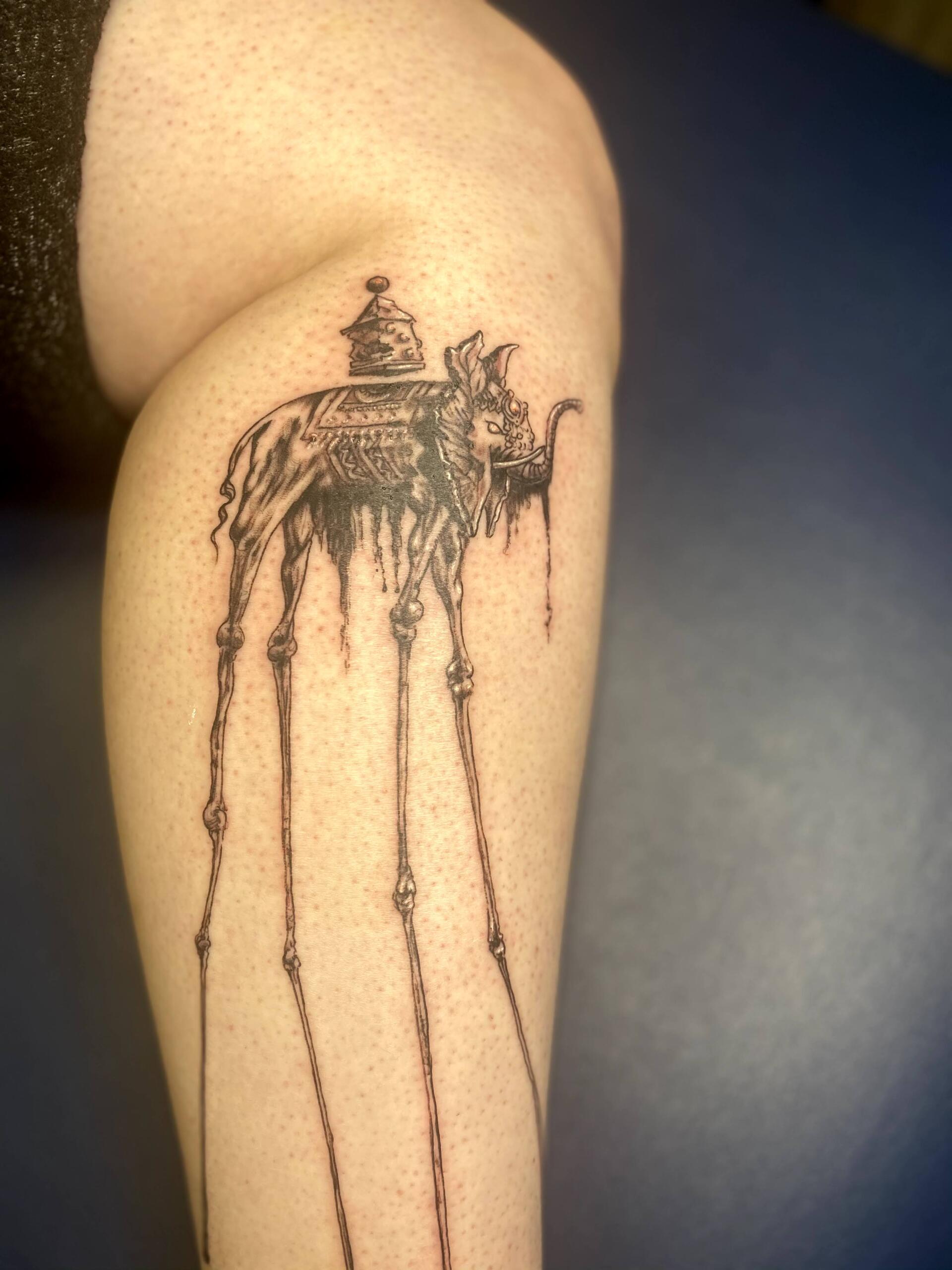 A woman has a tattoo of an elephant on her leg
