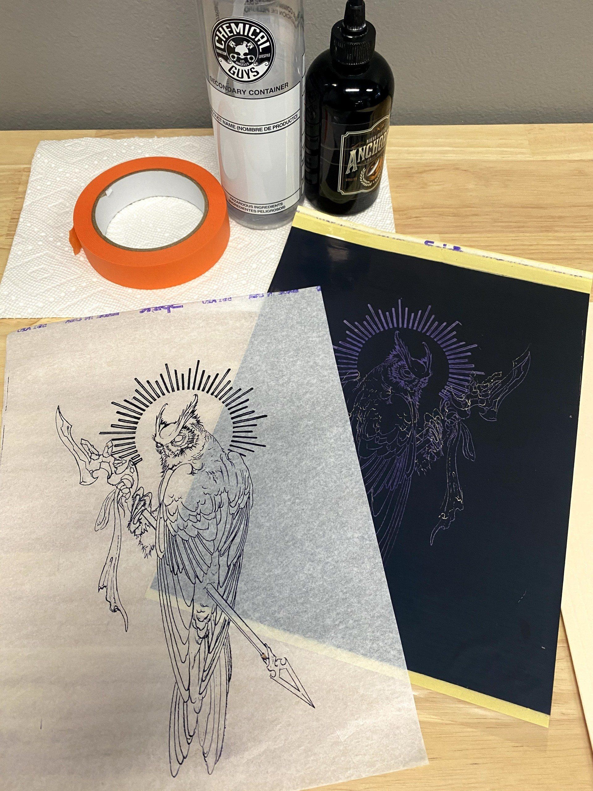 A bottle of kleenex sits on a table next to a drawing