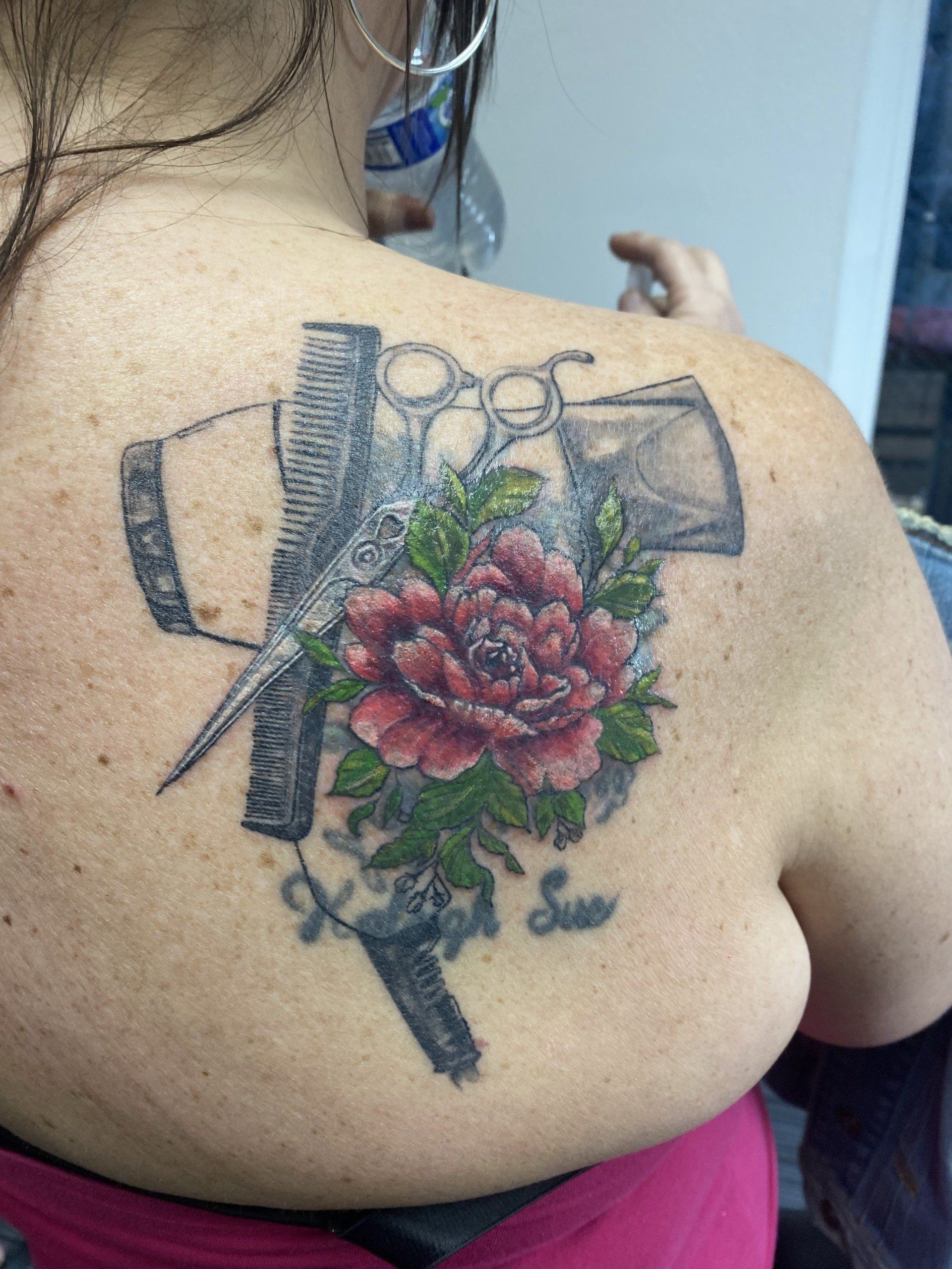 tattoo of shears and comb with flower