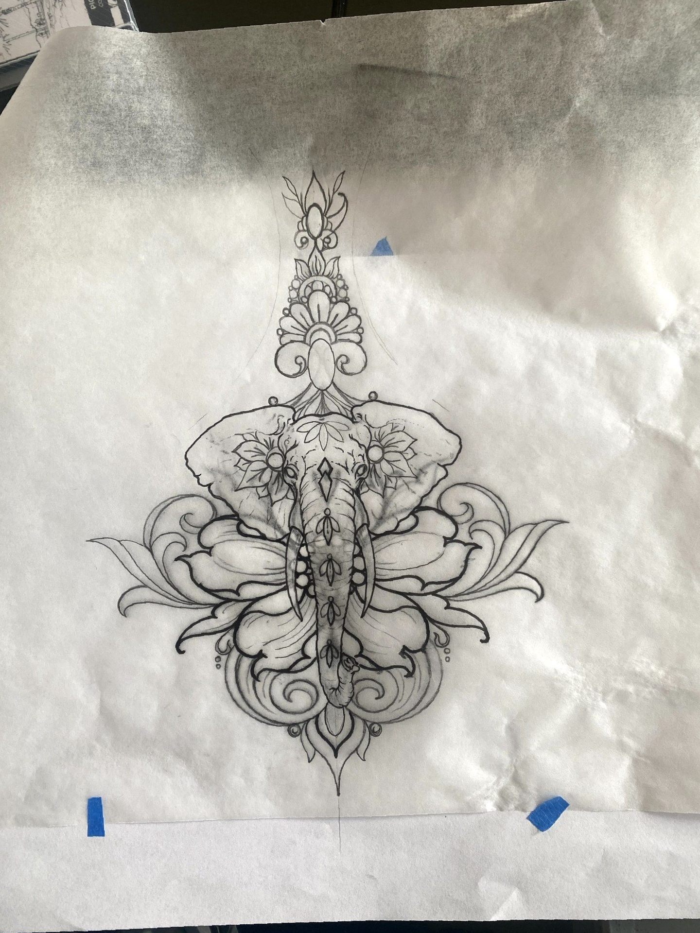 A black and white drawing of an elephant on a piece of paper