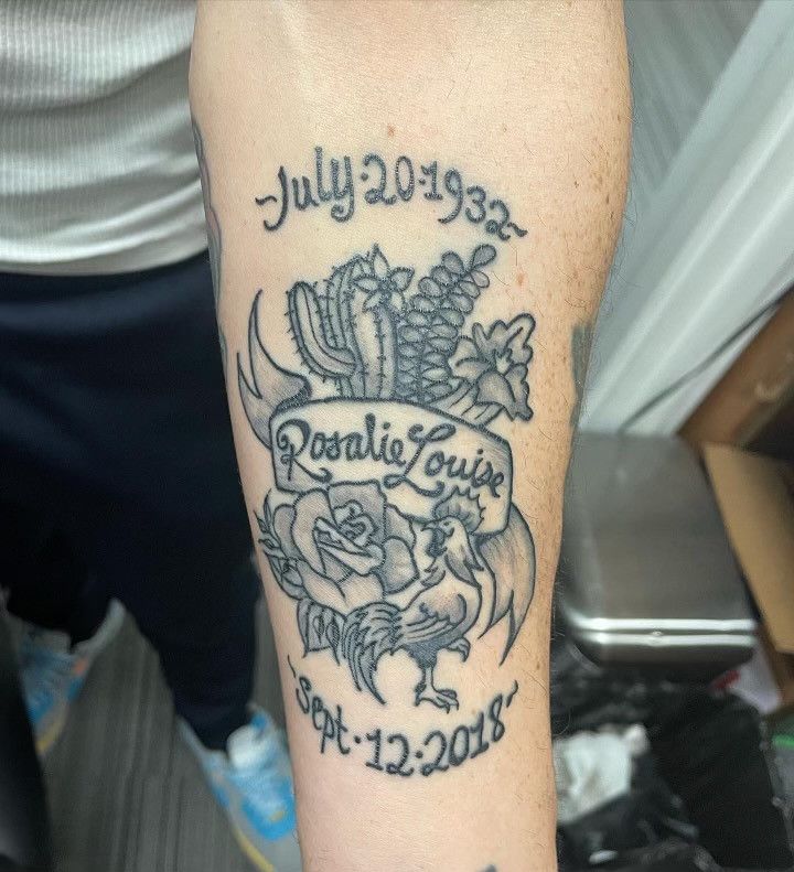 A person has a tattoo of rosalie louise on their arm
