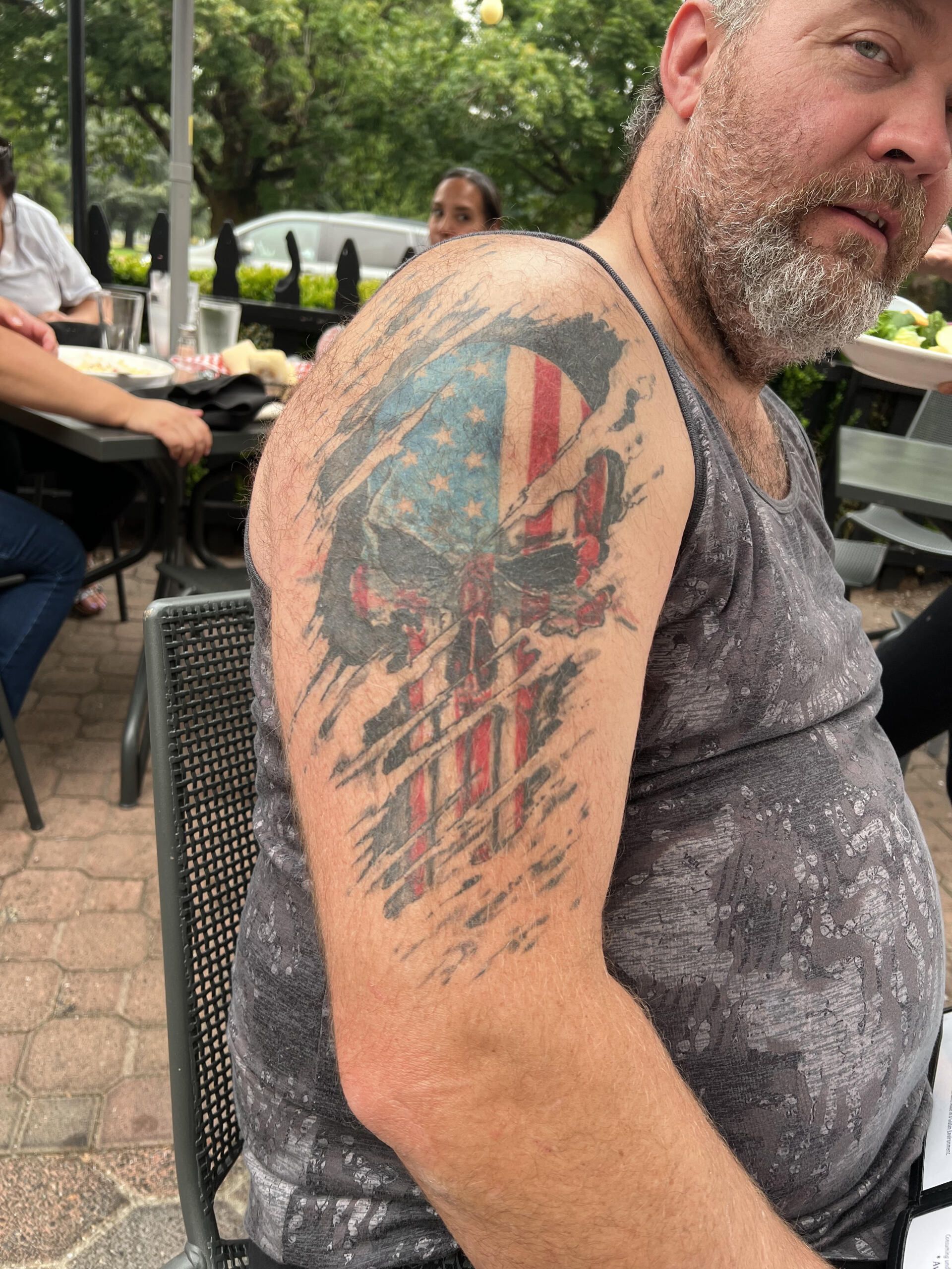 A man with a punisher tattoo on his arm