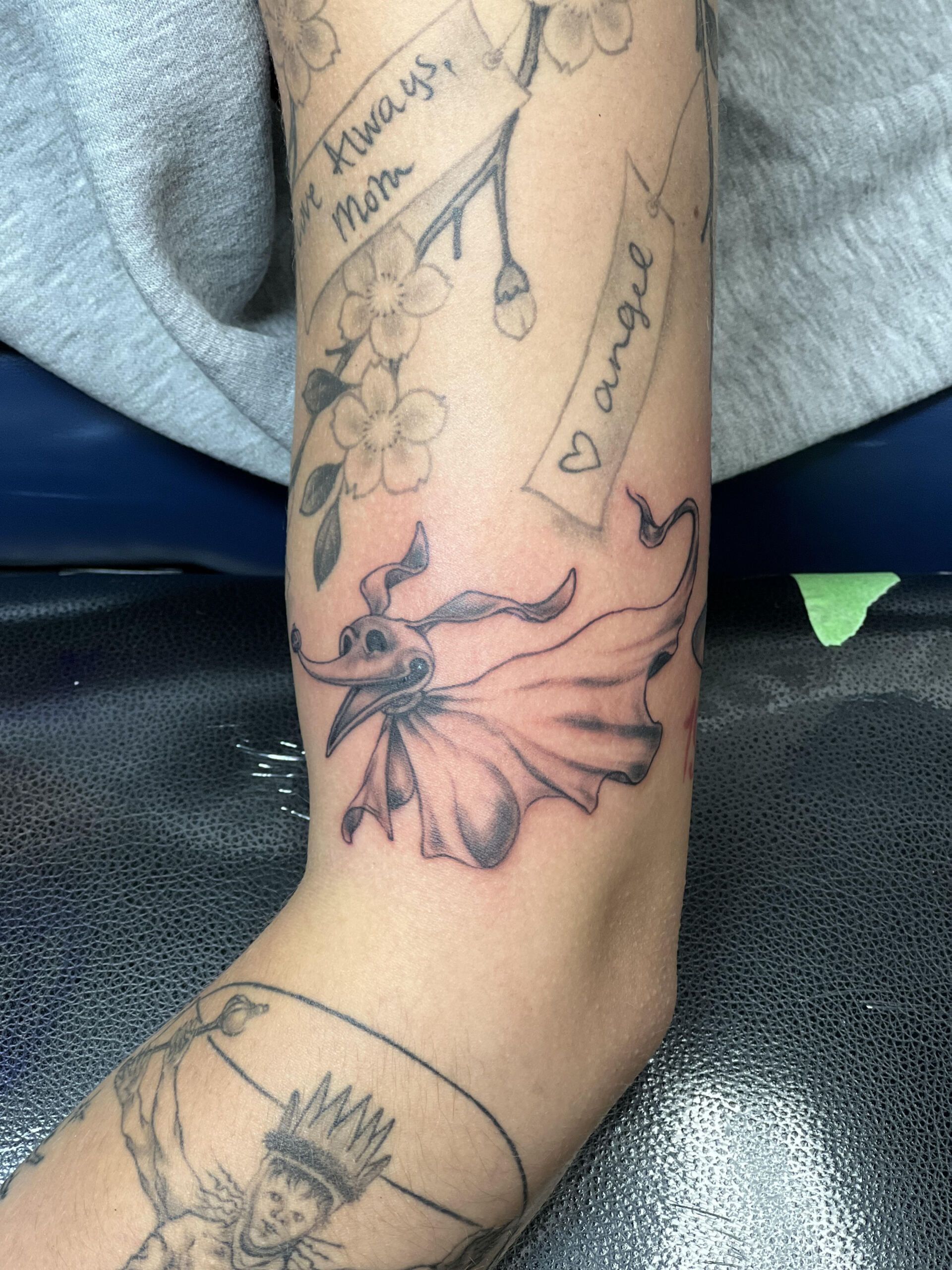 A woman has a tattoo on her arm that says 