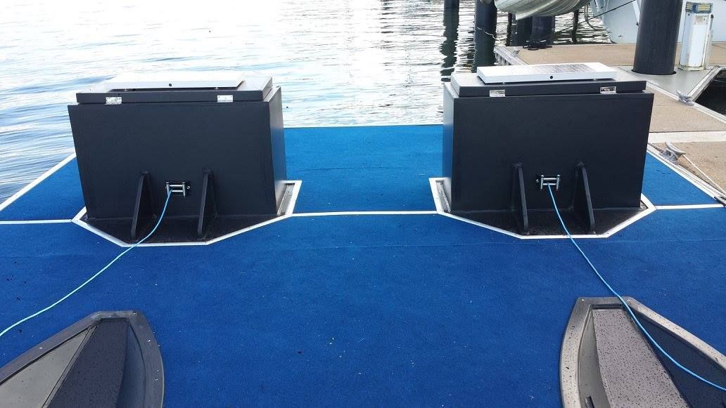 A Boat is Docked at a Dock With a Blue Carpet — V.I.P. Plastic Fabrication in Portsmith, QLD