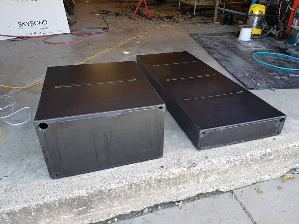 Two Black Boxes Are Sitting on the Sidewalk in a Garage — V.I.P. Plastic Fabrication in Townsville, QLD