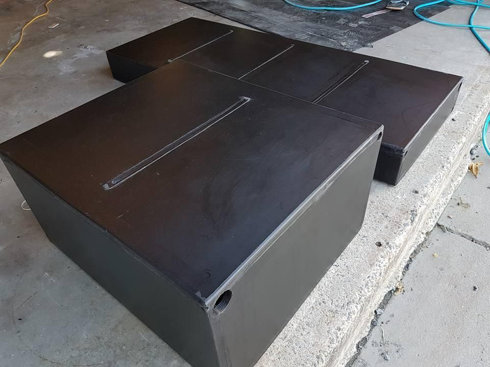 Two Black Boxes Are Sitting on Top of Each Other on the Ground — V.I.P. Plastic Fabrication in Cairns, QLD