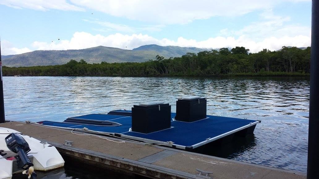 A Boat Is Docked at A Dock on A Lake — V.I.P. Plastic Fabrication in Portsmith, QLD