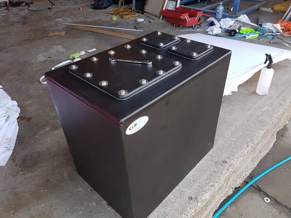 A Black Box is Sitting on a Concrete Surface Next to a Spray Bottle — V.I.P. Plastic Fabrication in Portsmith, QLD