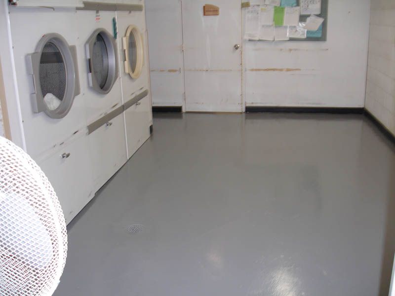 A laundromat with a fan in the foreground