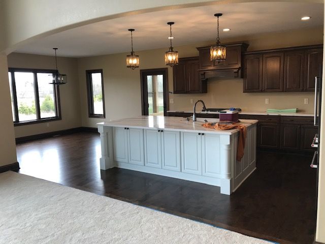 An empty kitchen with a large island in the middle