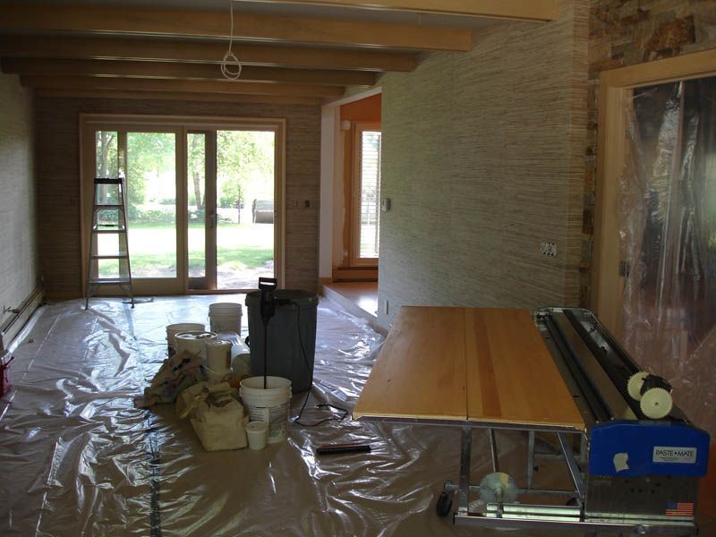 A room with a table and buckets on the floor