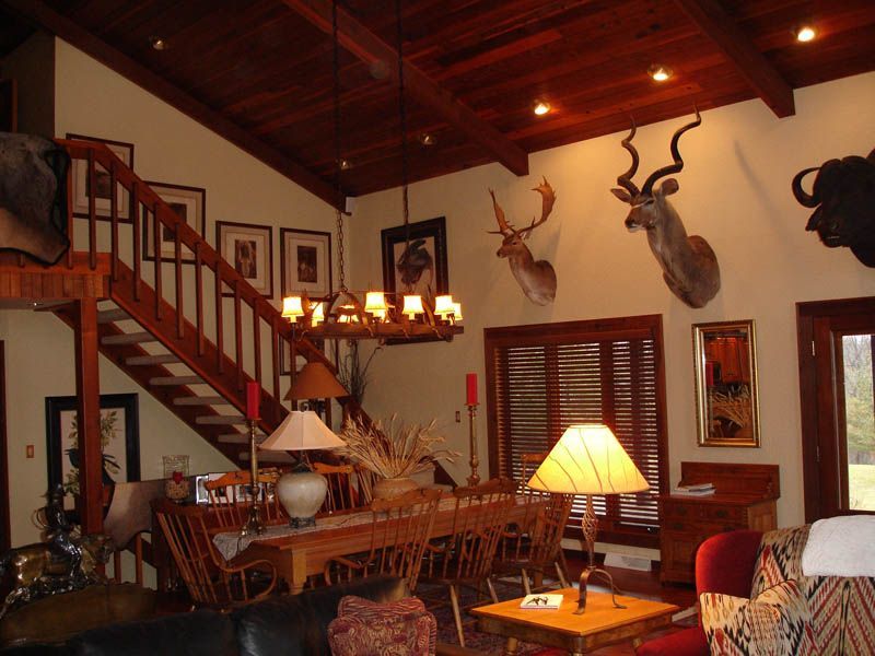 A living room with a staircase leading up to the second floor