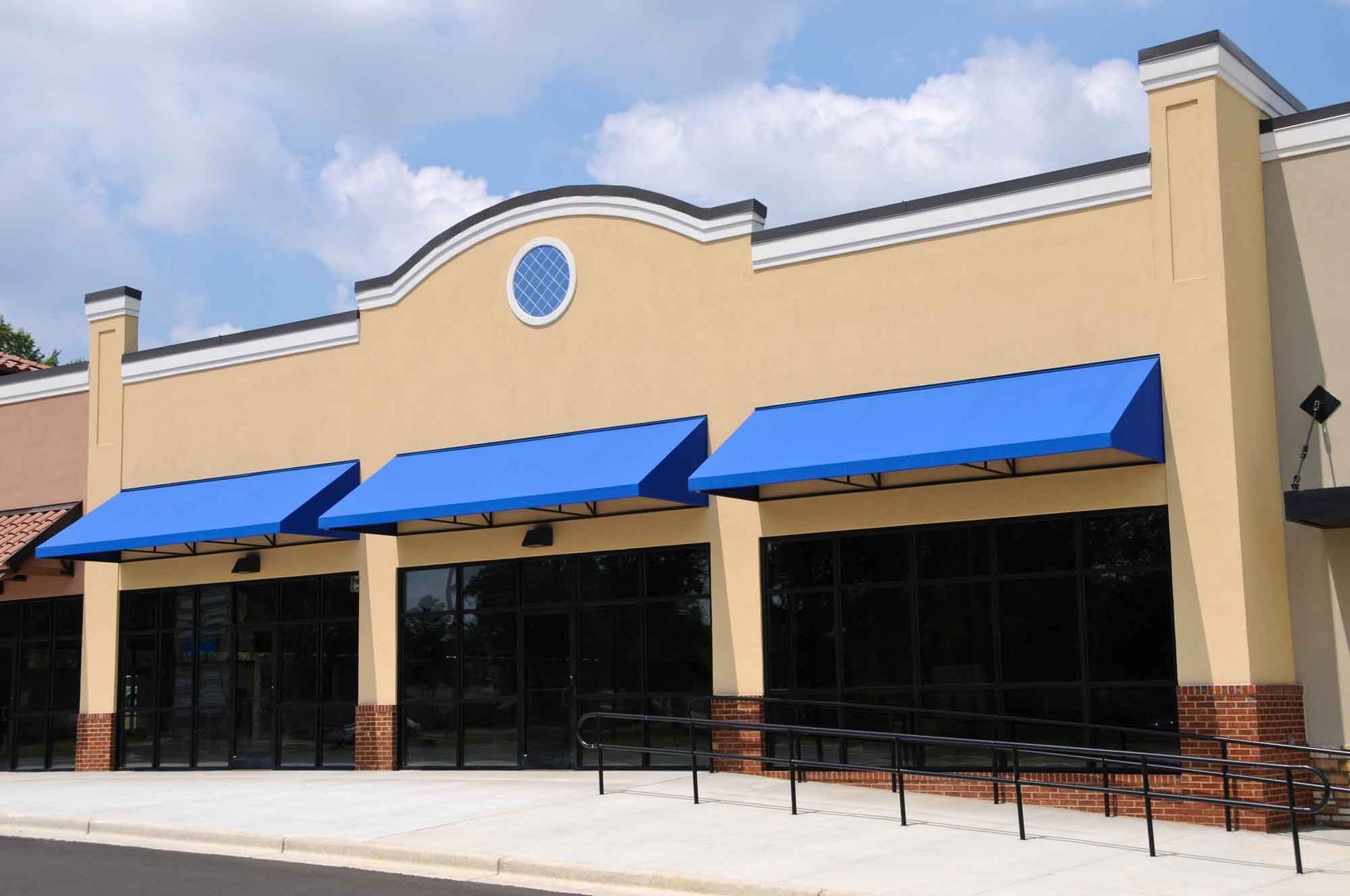 A building with blue awnings on the side of it