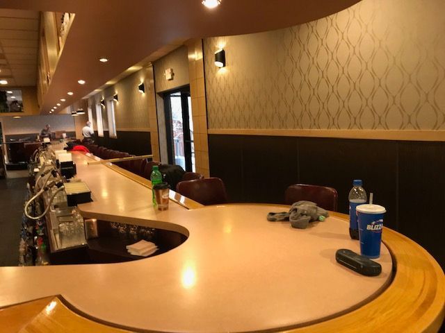 A bar in a restaurant with a bottle of blue ribbon on it