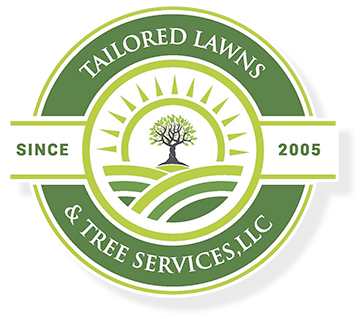 A logo for tailored lawns and tree services llc