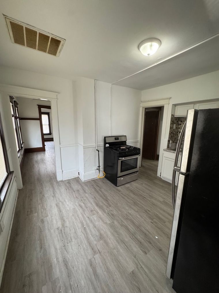 There is a stove and a refrigerator in the kitchen.