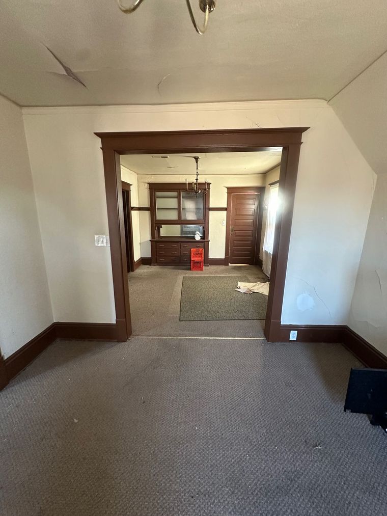 There is a doorway between the living room and the dining room.