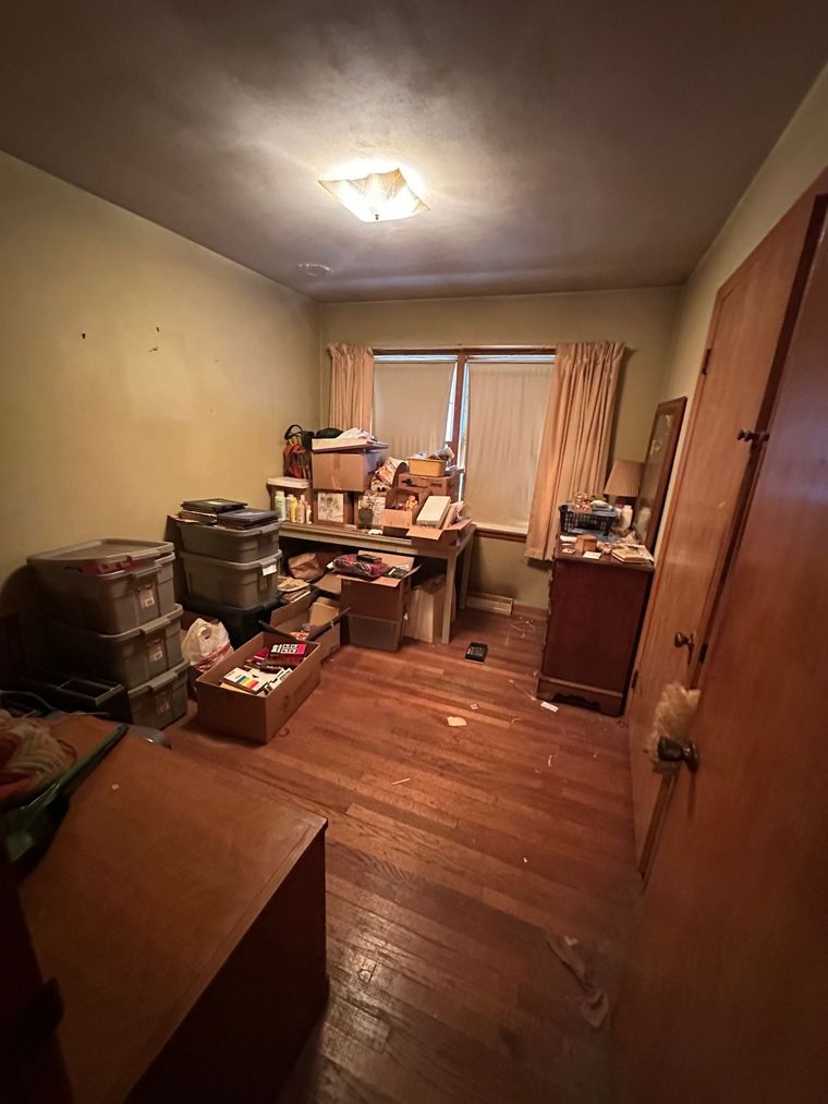 A room filled with lots of boxes and a desk.