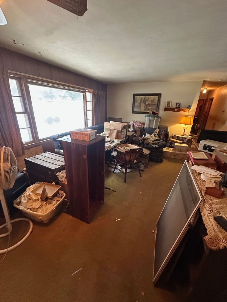 A living room filled with furniture and a fan.